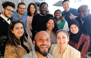 A group of people smile for a selfie