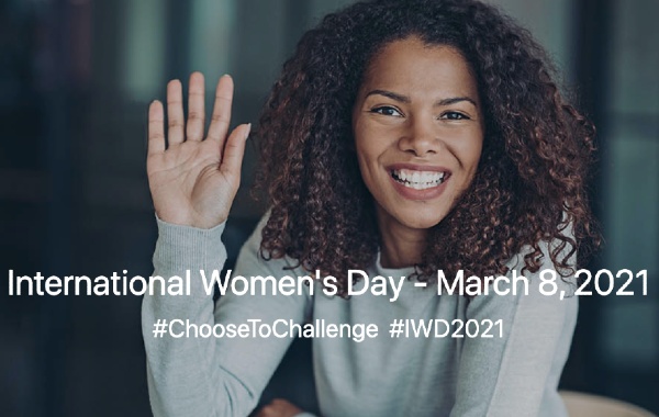 A woman smiles and waves her hand. Text in the image says International Women's Day March 8 2021. #ChooseToChallenge #IWD2021