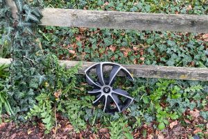 And car wheel against a fence