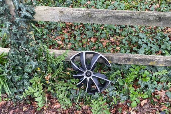 And car wheel against a fence