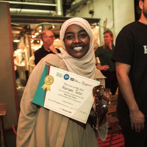 Mariam Tahir, founder of Coffee with kids, holds her certificate