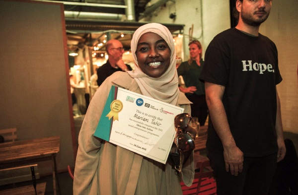 Mariam Tahir, founder of Coffee with kids, holds her certificate